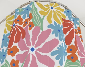 May include: A white shower curtain with a colourful floral design. The pattern includes large flowers in pink, orange, yellow, and blue, with green leaves. The curtain hangs from a curved metal rail.
