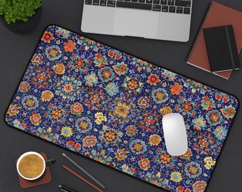 May include: A blue and colorful floral patterned mouse pad with a white computer mouse on top of it.