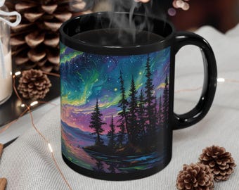 May include: Black coffee mug with a colorful aurora borealis scene and a silhouette of a forest. The mug has a white rim and handle.