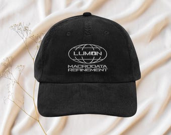 May include: Black corduroy baseball cap with a white embroidered logo that reads "LUMON MACRODATA REFINEMENT" with a globe graphic.