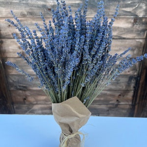 May include: A bouquet of dried lavender flowers tied together with twine and wrapped in brown paper.