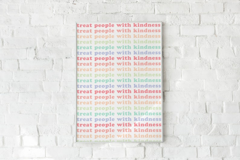 May include: A white framed print with the text "treat people with kindness" repeated in a rainbow of pastel colors.