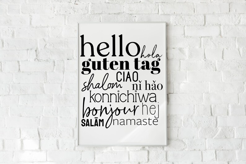 May include: A white framed print with black text that says "hello hola guten tag ciao shalom ni hao konnichiwa bonjour hej salam namaste".