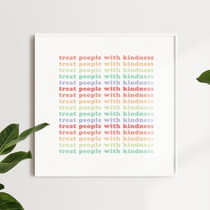 May include: A white framed print with the text "treat people with kindness" repeated 16 times in a vertical column. The text is in a rainbow of colors, including red, orange, yellow, green, blue, and purple.