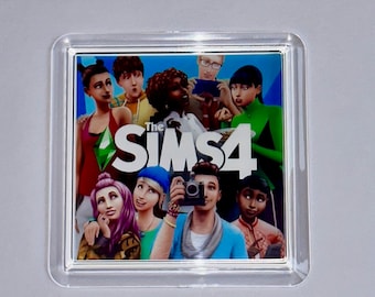 May include: A clear plastic coaster featuring a colourful image of characters from the Sims 4 video game. The characters are smiling and interacting, with the text "The Sims 4" prominently displayed in the centre of the image.