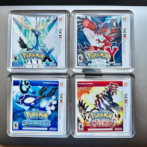 May include: Four Nintendo 3DS game cases for Pokemon X, Pokemon Y, Pokemon Alpha Sapphire, and Pokemon Omega Ruby. The cases are all blue and red with the Pokemon logo and the game title.