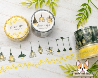 May include: Two rolls of clear tape with a lightbulb theme. One roll features a string of fairy lights and the other features pendant lights. The tape is decorated with a variety of lightbulbs, including a star-shaped lightbulb and a caged lightbulb.