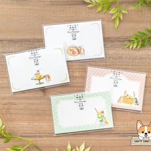May include: Set of five blank mini message cards featuring a cute corgi dog design. Each card has a different illustration of the corgi with a dessert or drink. The cards are perfect for writing a short message or note.