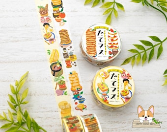 May include: Decorative washi tape rolls with pancake and breakfast food illustrations. The tape features stacks of pancakes, syrup, fruit, and other breakfast items. The rolls are packaged in clear plastic and are on a white wooden surface.