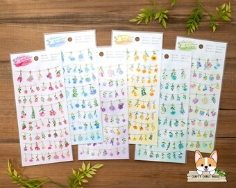 May include: Five sheets of floral garland stickers with watercolor illustrations of flowers in pink, blue, yellow, and purple. Each sheet has the text "Flower Garland Stickers" and "Crafty Corgi House".