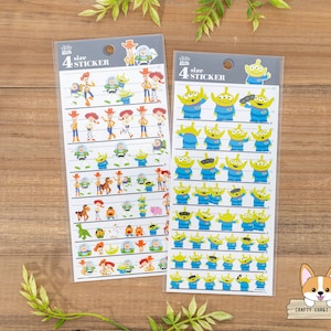 May include: Two sheets of Toy Story stickers. The left sheet features characters from Toy Story, including Woody, Buzz Lightyear, Jessie, and Rex. The right sheet features the alien characters from Toy Story. Each sheet has the text "4 size STICKER".