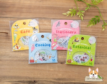 May include: Four packs of mini animal stickers in clear plastic packaging. The packs are yellow, pink, blue, and green, with the themes "Cafe", "Stationery", "Cooking", and "Botanical". Each pack contains 45 pieces.
