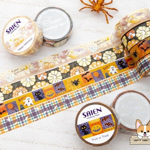 May include: A set of Halloween themed washi tapes with various designs including pumpkins, ghosts, bats, spiders, and the text "Trick or Treat". The tapes are in shades of orange, black, white, and purple.