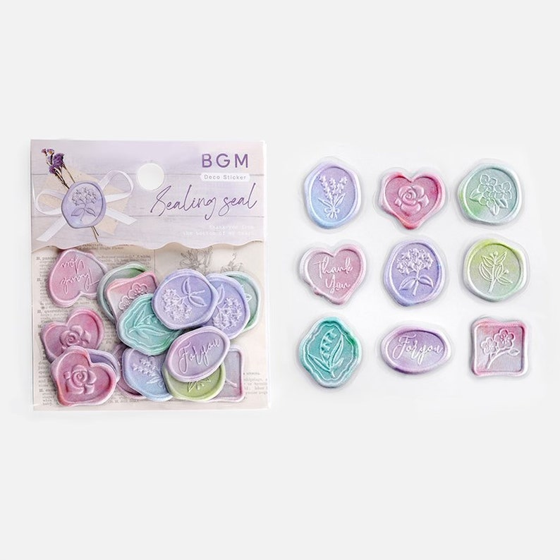 May include: A sheet of colorful, pastel-colored, decorative wax seal stickers. The stickers feature various floral designs and phrases like "Thank You" and "For You".