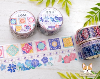 May include: Assortment of colorful washi tapes with geometric and floral patterns. The tapes are labeled "CLEAR TAPE BGM PETRN".