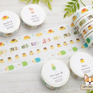 Puede incluir: Surtido de cintas washi de colores con postres japoneses, incluyendo pudín, parfait y arroz con tortilla. Cada cinta mide 15 mm de ancho y 10 m de largo. Las cintas están etiquetadas con los nombres japoneses de cada postre.