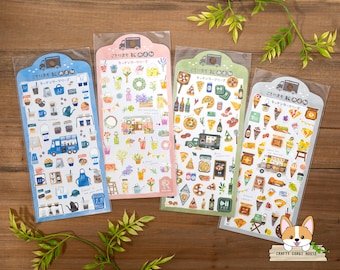 May include: Four sheets of colorful stickers featuring illustrations of food trucks and food items. The stickers are labeled "Kitchen Car Series" and include images of coffee, pizza, ice cream, and other treats.