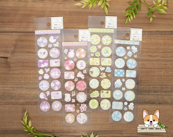 May include: Four sheets of colorful stickers featuring various designs, including birds, flowers, and geometric patterns. The stickers are packaged in clear plastic sheets with the brand name "WAKUWAKU" printed on each sheet.