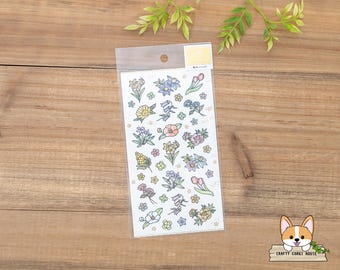 May include: A sheet of clear sticker paper with a variety of colorful flower illustrations. The flowers are in various shades of pink, blue, yellow, and green. The stickers are perfect for adding a touch of whimsy to journals, planners, and other paper crafts.