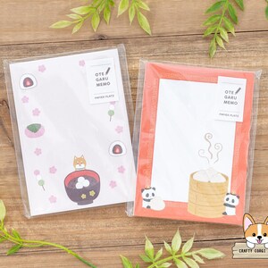 May include: Two sets of blank memo pads with cute illustrations. The first set features a Shiba Inu dog with a bowl of red bean soup. The second set features a panda bear with a steaming bowl of dumplings. Both sets have the text "OTE GARU MEMO" and "PAPER PLATE" printed on them.