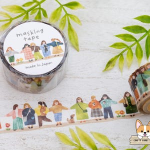 May include: Masking tape roll with a repeating illustration of people holding hands. The tape roll has the words "masking tape" and "Made in Japan" printed on it. The tape is decorated with a floral and green leaf design.