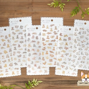 May include: Six sheets of clear sticker paper with a scalloped edge. Each sheet features a different design of adorable cartoon puppies in various poses. The text "わんこ(ワンコ)  Sticker" is printed on each sheet.