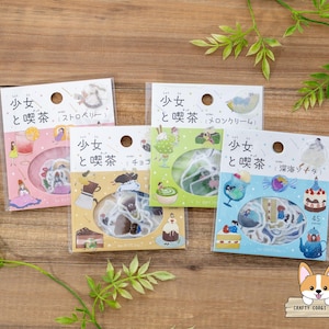 May include: Four packs of decorative stickers with Japanese text and illustrations. Each pack features a different theme: strawberry, chocolate, melon cream, and deep sea. The stickers are in clear plastic packaging, with a variety of colourful designs.
