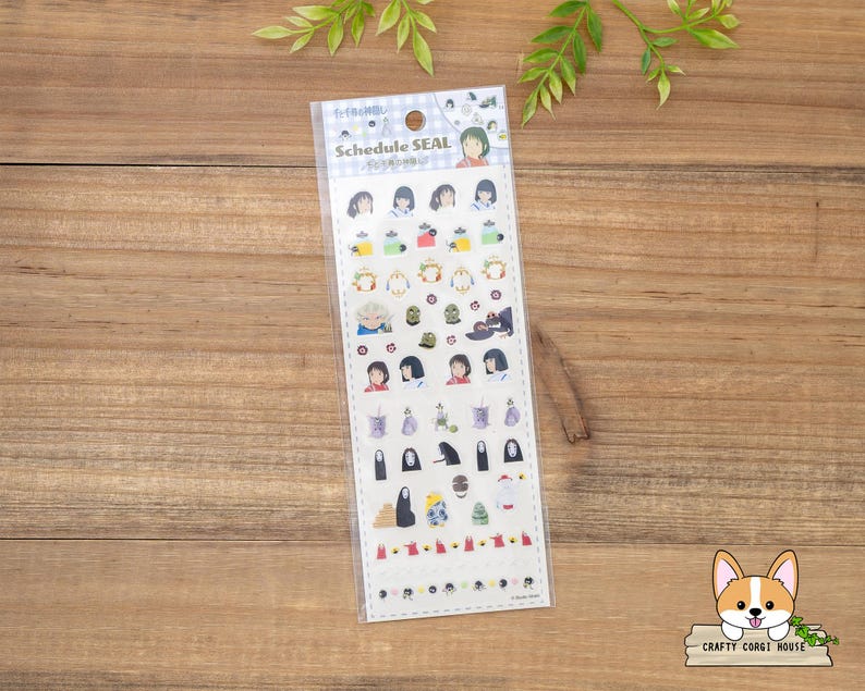 May include: A clear plastic package of schedule seal stickers. The stickers feature various illustrations of characters and objects. The text "Schedule SEAL" is printed at the top of the package. The stickers are on a wooden surface.