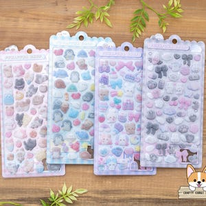 May include: Four sticker sheets with various cute designs, including animals, bows, and clouds. The stickers are in pastel colors like pink, blue, and purple. Each sheet is in a clear plastic package with the text "FUNAFUNA SHOP" at the top.