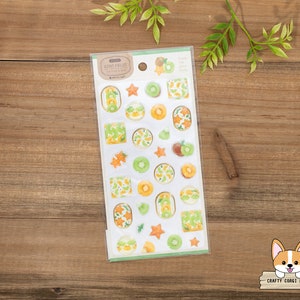 May include: A sheet of clear stickers with illustrations of kiwi fruit slices, kiwi fruit halves, and kiwi fruit stars. The stickers are on a white background with the text "Kiwi Fruit" in a brown rectangle.