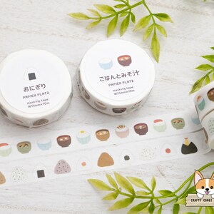 May include: Two rolls of white washi tape with Japanese characters and illustrations of bowls of rice and soup. The tape is 1.5 cm wide and 10 meters long.