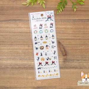 May include: A clear plastic package containing a sheet of schedule stickers. The stickers feature illustrations of cartoon characters, cats, lanterns, and other Halloween-themed designs. The text "SCHEDULE SEAL" is printed at the top.