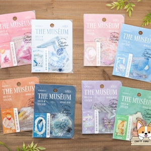 May include: Eight clear sticker packs with a variety of designs. Each pack has a light blue, pink, purple, or green background with the text "THE MUSEUM" in white. The stickers feature illustrations of butterflies, flowers, and other nature-inspired designs.