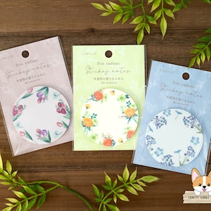 May include: Three packs of colorful floral sticky notes with the text "Bon cadeau Stickey notes 半透明の透けるふせん 30 SHEETS" on each pack. The sticky notes are round and feature different floral designs.