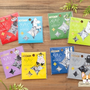 May include: Ten colorful sticker sheets featuring Moomin characters. Each sheet has a different design and includes the text "Moomin - Kira Kira - Clear Flake Seal".
