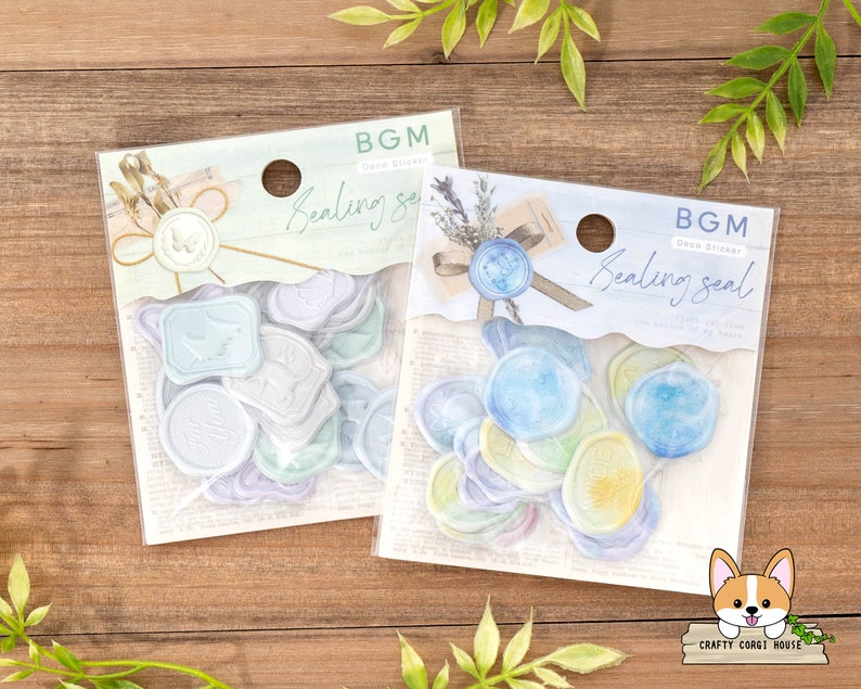 May include: Two packs of sealing wax stickers. The stickers are in the shape of wax seals and have a watercolor design. The stickers are labeled "BGM Drop Sticker Sealing Seal".