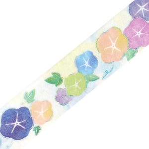 May include: Decorative washi tape featuring a repeating pattern of colorful morning glory flowers. The flowers are in shades of blue, purple, orange, and green, with silver accents. The tape has a light yellow background with a watercolor effect.