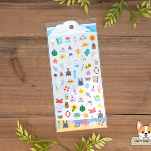 May include: A sheet of colorful summer-themed stickers featuring images of ice cream, watermelon, seashells, crabs, and more. The stickers are on a white background with a blue border.