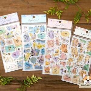 May include: Four sheets of colorful stickers with gold accents. The stickers feature various illustrations including musical instruments, hearts, flowers, and other whimsical designs. The stickers are packaged in clear plastic sleeves with the text "Lagard Soul" printed on each sheet.