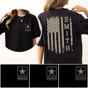 May include: Black t-shirt with a distressed American flag design on the back and the name "SMITH" printed vertically. The front features a star emblem and the text "PROUD MOM". Additional designs include "PROUD DAD", "PROUD SISTER", and "PROUD BROTHER".