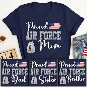 May include: Navy blue t-shirts with the text "Proud Air Force Mom", "Dad", "Sister", and "Brother". Each shirt features an American flag graphic and a dog tag with the name "VANN".