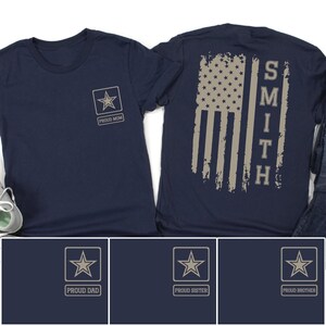 May include: Navy blue t-shirts with a star emblem and the words "PROUD MOM" on the front. The back of the shirt features a distressed American flag design with the name "SMITH" vertically aligned. Additional shirts with "PROUD DAD", "PROUD SISTER", and "PROUD BROTHER" are also shown.
