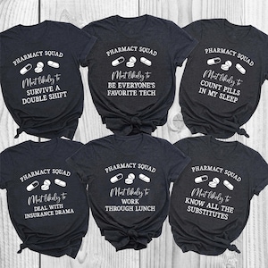 May include: Six dark gray t-shirts with white text and pill graphics. Each shirt features the text PHARMACY SQUAD and unique phrases including Most likely to SURVIVE A DOUBLE SHIFT, BE EVERYONE'S FAVORITE TECH, COUNT PILLS IN MY SLEEP, DEAL WITH INSURANCE DRAMA, WORK THROUGH LUNCH, and KNOW ALL THE SUBSTITUTES.