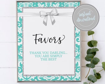 May include: A framed sign with a white background, featuring the word "Favors" in elegant script. The sign has a teal and silver damask border, a silver ribbon, and a bow. The text "THANK YOU DARLING... YOU ARE SIMPLY THE BEST" is also included.