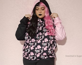 Pastel Goth Fleece Pullover Hoodie, Kawaii Spooky Axolotl Skeleton Print Color Block, Black & Pink Split Color, Cute Emo Goth Hoodie