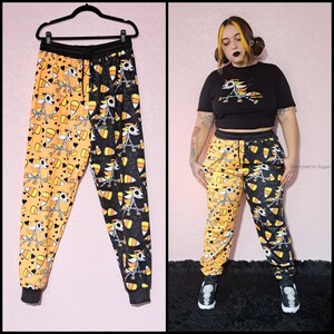 Pastel Goth Jogger Sweatpants, Kawaii Spooky Candy Corn Skeleton Unicorn Print Split Black & Orange, Cute Goth Jogger Pants with Pockets