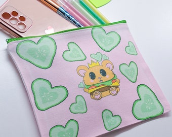 May include: A pink canvas zippered pouch with a cartoon hamster wearing a crown and holding a burger. The pouch is decorated with green heart-shaped designs and the text "Drenched in Sugar".