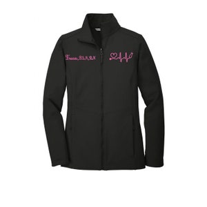 May include: Black softshell jacket with a zipper closure and two front pockets. The jacket has pink embroidery that reads "Erica, BSN, RN" and a pink heart with a stethoscope and EKG line.