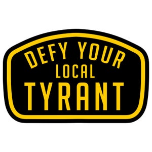 May include: Black and yellow sticker with the text "Defy Your Local Tyrant" in a bold, sans-serif font.