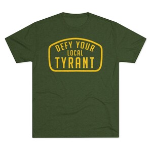 May include: A green t-shirt with a yellow graphic that says "Defy Your Local Tyrant".